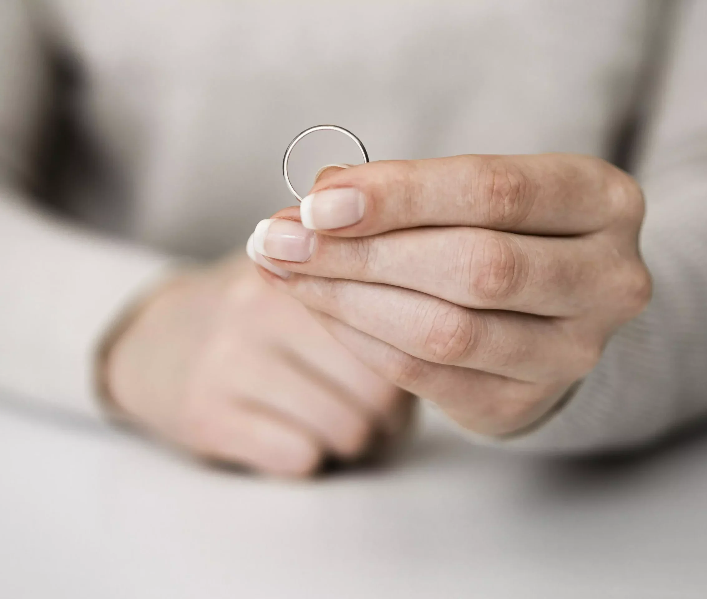 woman-holding-marriage-ring-1-scaled-e1780500434714.webp